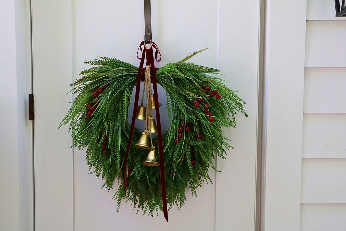 Cascading beaded-grass wreath with red berries, burgundy velvet ribbon and five hanging gold-tone bells.