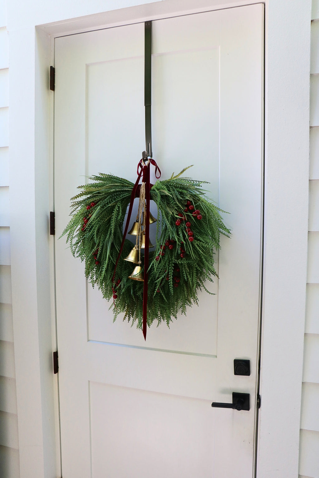 Cascading beaded-grass wreath with red berries, burgundy velvet ribbon and five hanging gold-tone bells.