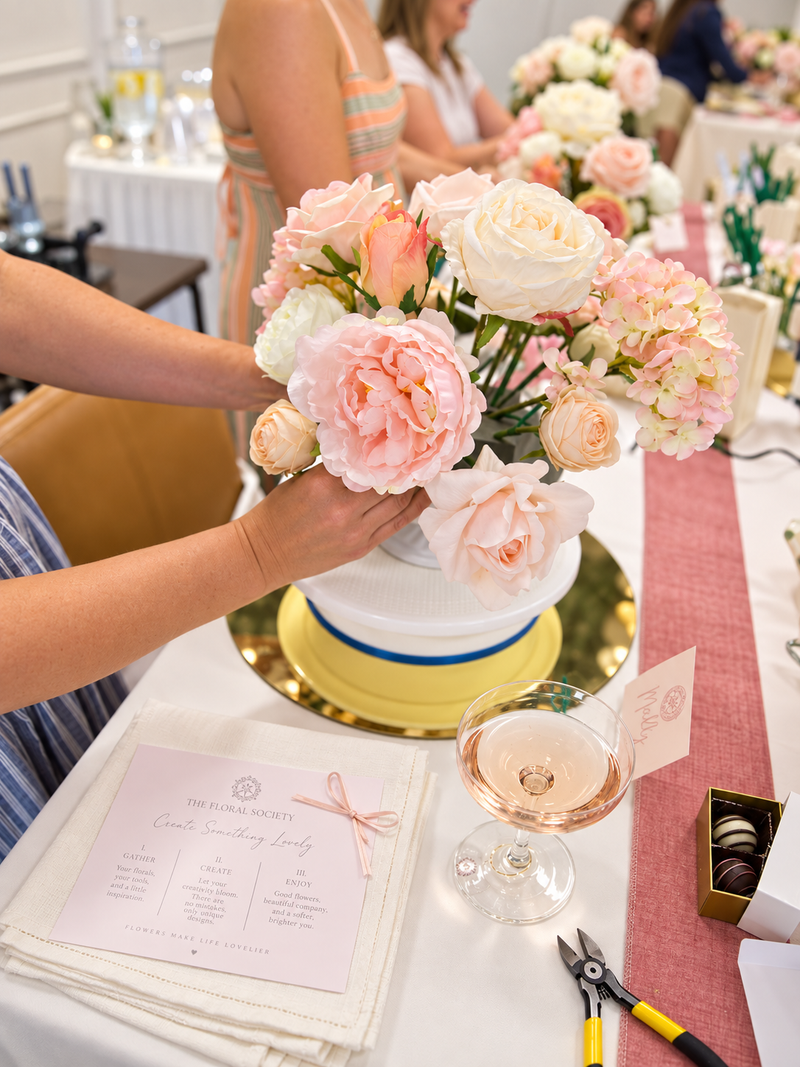 Blush and ivory faux floral arrangement being created at a Sip & Style workshop.